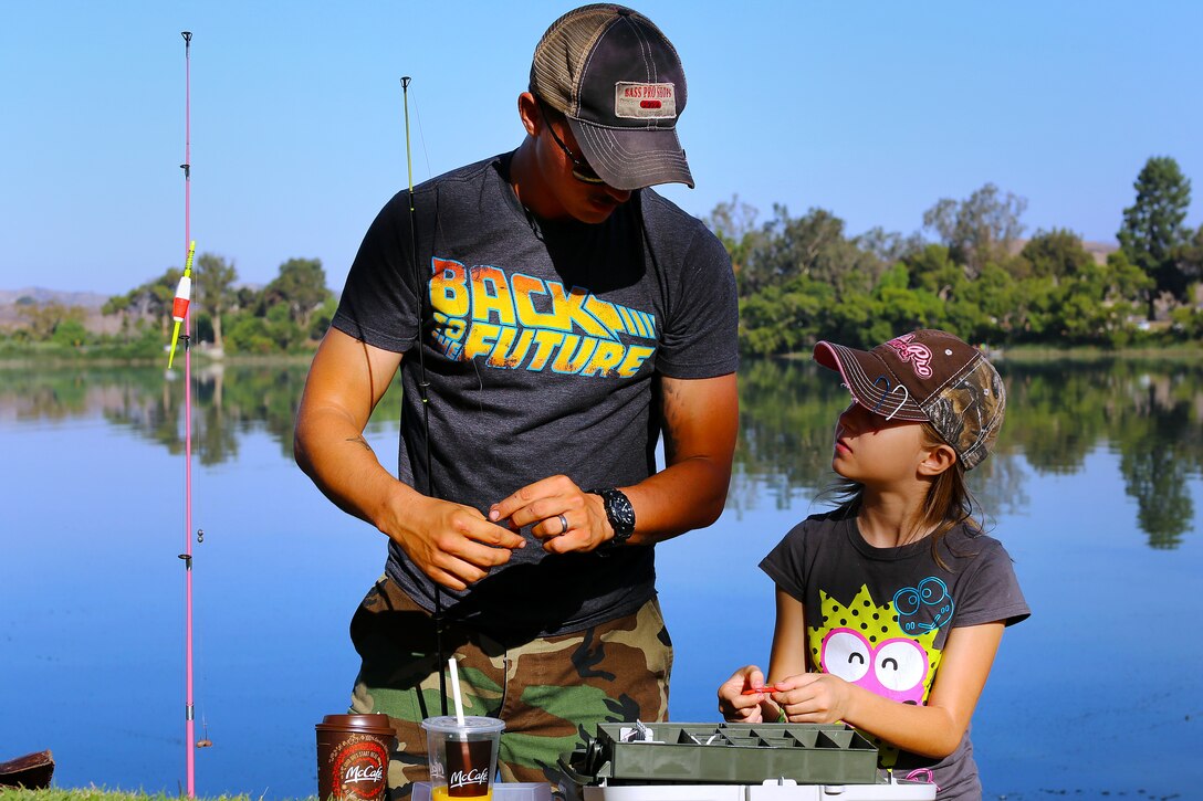 Nathaniel Houck, and his daughter Alexandera, 9, prepare their hooks while competing in the 9th annual Lake O'Neill Kids Fishing Derby, here, Sept. 6.

The fishing derby is a competition where children attempt to catch the largest fish they can while competing in three to five, six to ten and eleven to fifteen age categories.

"This event is designed to get kids out of the house where they can learn and have a fun outdoor experience," said Dolores Perez, a recreation specialist with Marine Corps Community Services' Semper Fit division. "I think this is a great way to keep them active and expose them to what could potentially be a new hobby."