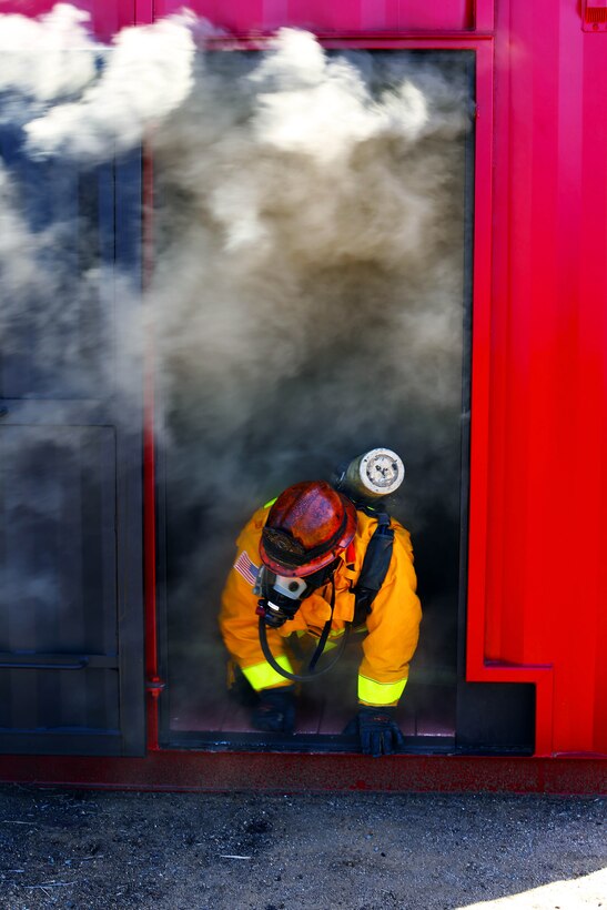 A firefighter vents off-gases from a fire simulator during an exercise conducted by the Camp Pendleton Fire Department and the Marine Corps Air Station Camp Pendleton’s Aircraft Rescue Fire Fighting unit on a controlled burn training facility at the 25 Area here.
“This is a Flashover simulator,” said Rick Clarke, a train-the-trainer instructor for Fire Training Structures. “This teaches firefighters how to prevent the rapid combustion of off-gas created by burned materials.”
