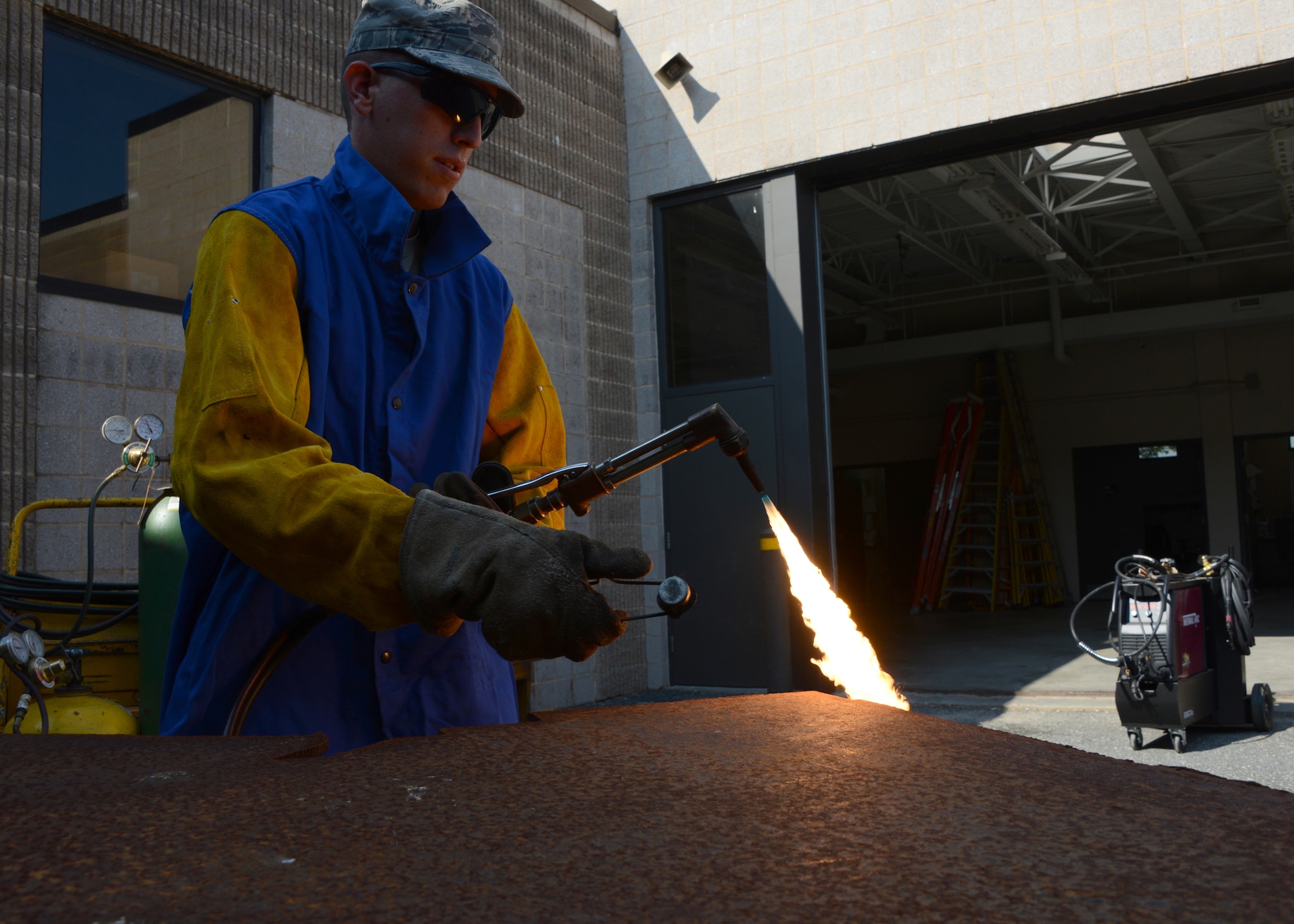 Senior Airman Andrew Bracken, structural journeyman assigned to the 175th Civil Engineering Squadron, Warfield Air National Guard Base, Baltimore, Md., lights an acetylene torch in preparation for a demonstration in raw cutting steel for fabrication purposes, September 6, 2014.  In addition to serving with the Maryland Air National Guard Bracken also volunteers his time with the Dallastown Volunteer Fire Department. (Air National Guard photo by Tech. Sgt. Christopher Schepers/RELEASED)