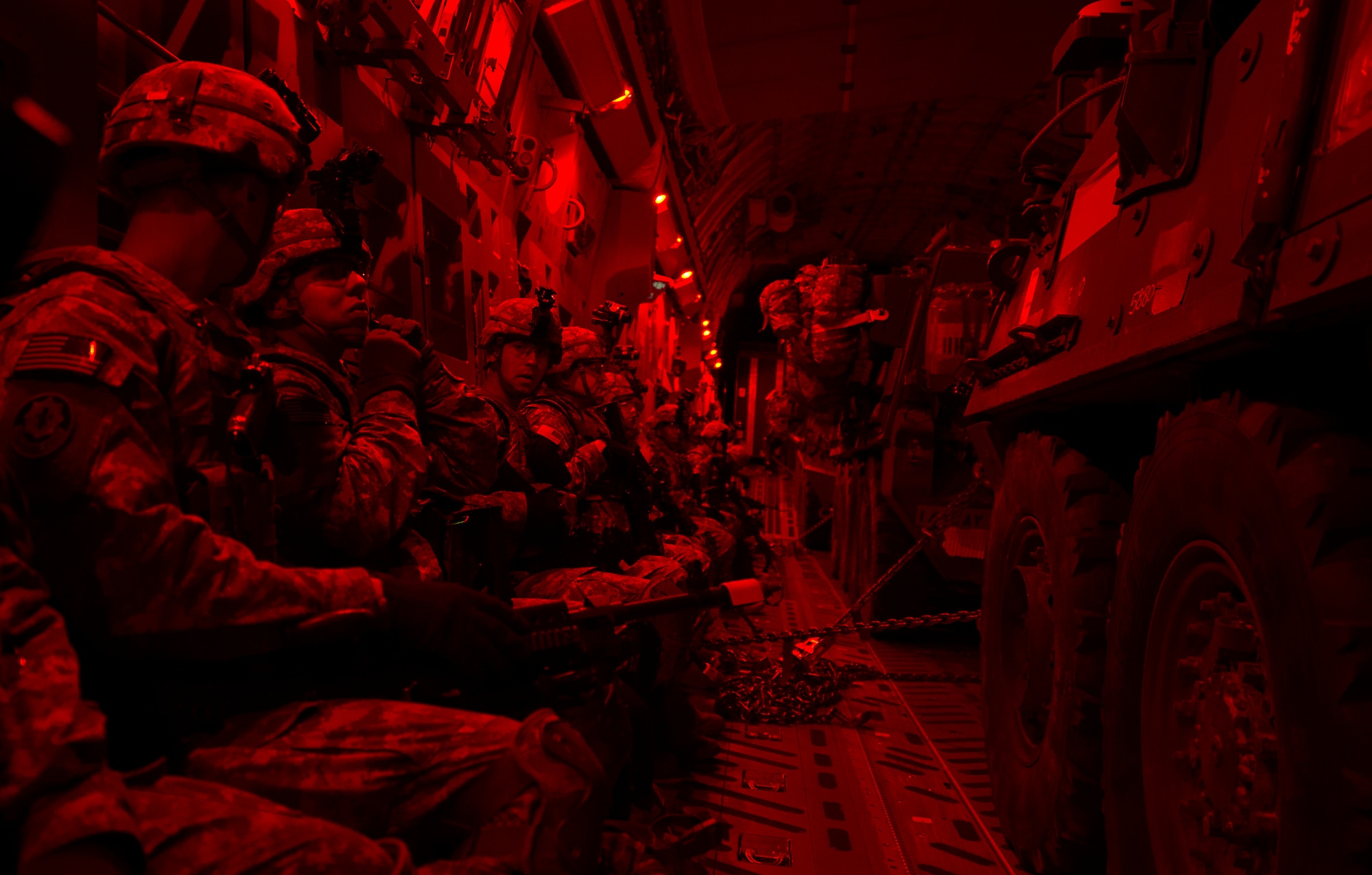 Soldiers assigned to Apache Troop, 1st Squadron, 2nd Cavalry Regiment prepare their equipment prior to boarding U.S. Army Strykers during Steadfast Javelin II in Latvia, Sept. 5, 2014. Steadfast Javelin II prepares U.S., NATO Allies and European security partners to conduct unified land operations through the simultaneous combination of offensive, defensive, and stability operations appropriate to the mission and the environment, and to sustain interoperability with partner nations. (U.S. Air Force photo/Senior Airman Damon Kasberg)