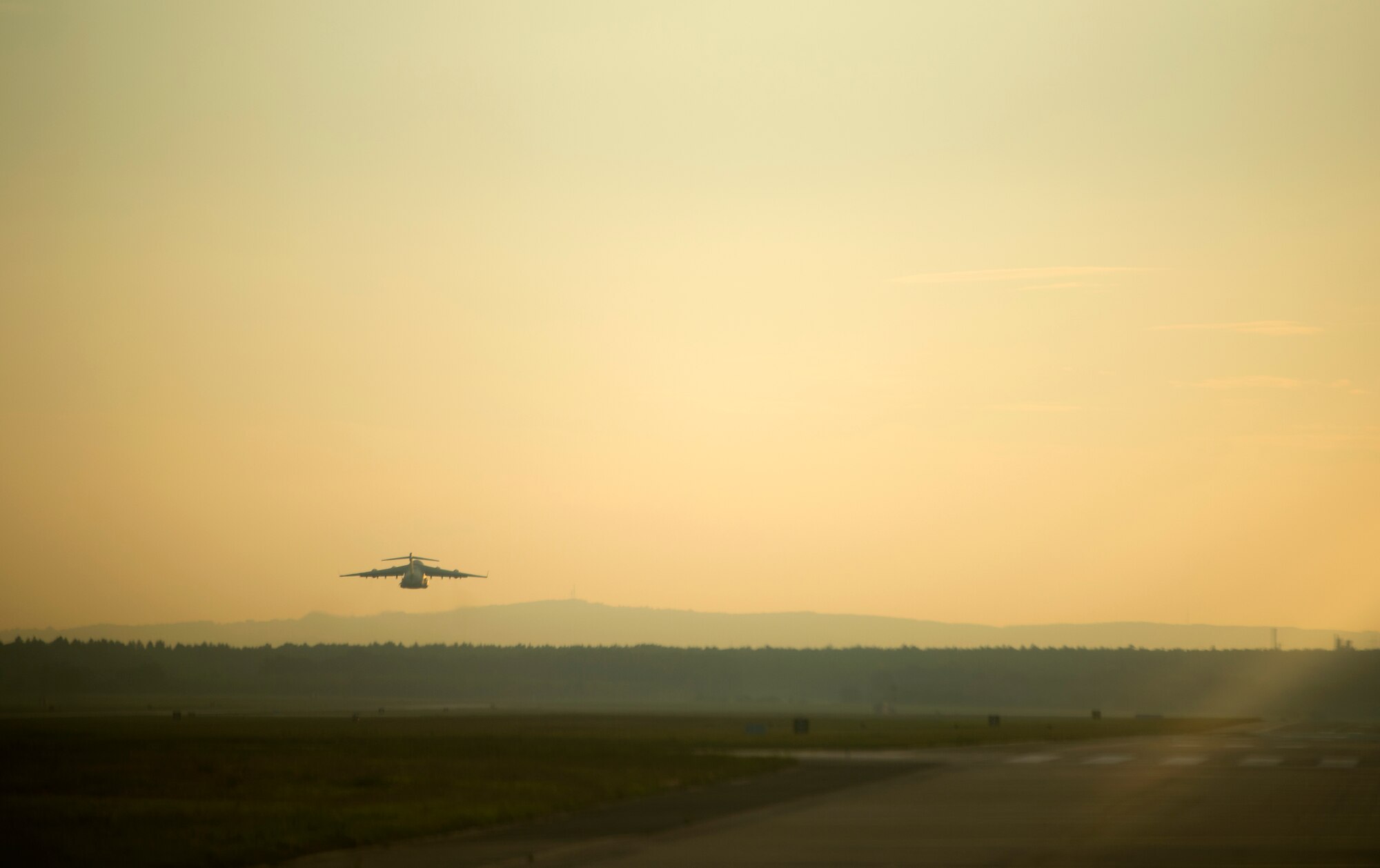 A C-17 Globemaster III assigned to the 37th Airlift Squadron, takes off from Ramstein Air Base, Germany, in support of Steadfast Javelin II, Sept. 5, 2014. Steadfast Javelin II is a NATO exercise involving over 2,000 troops and takes place across Estonia, Germany, Latvia, Lithuania and Poland. The exercise focuses on increasing interoperability and synchronizing complex operations between allied air and ground forces through airborne and air assault missions. (U.S. Air Force photo/Senior Airman Damon Kasberg)