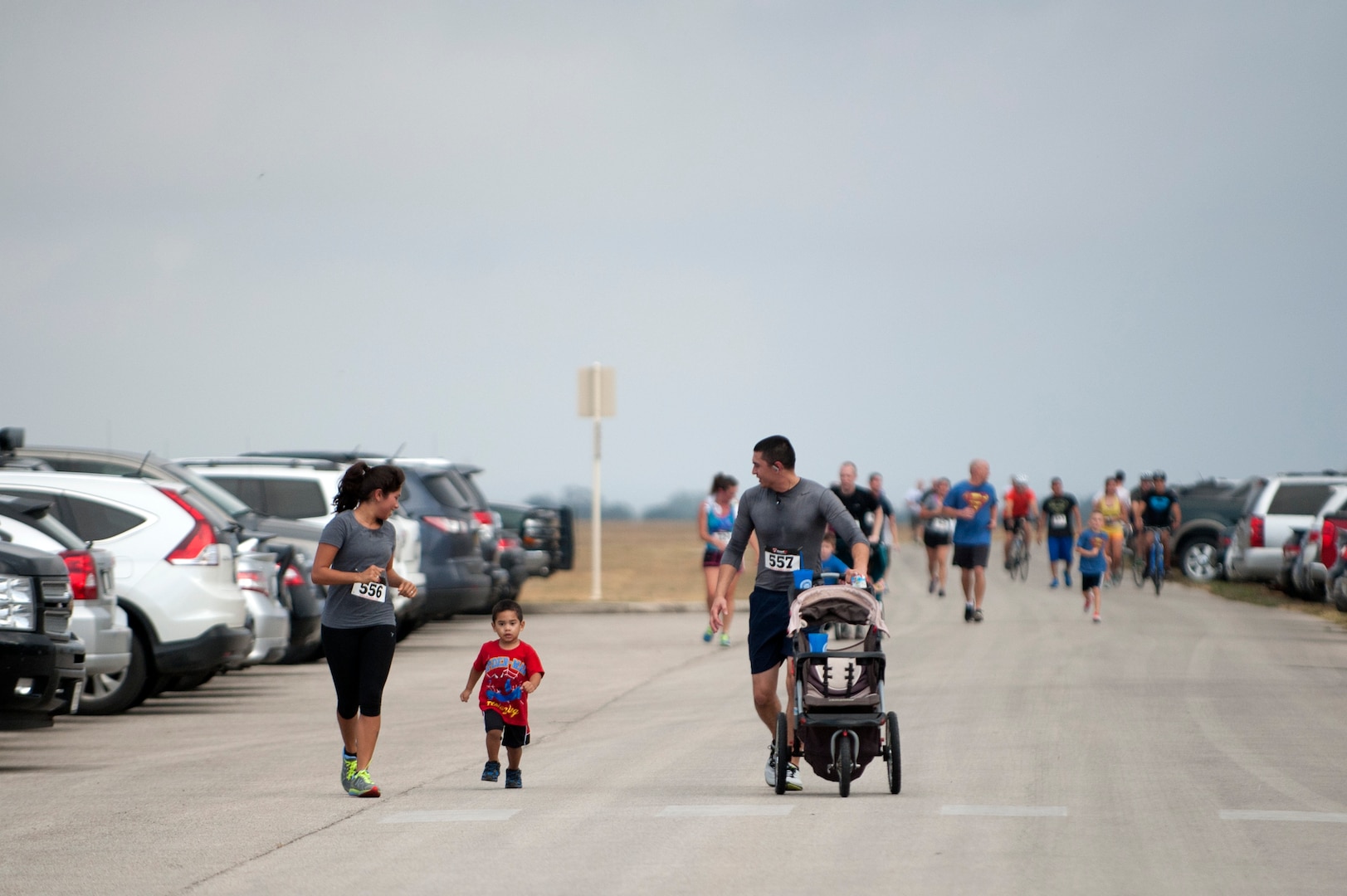 Angelica Evans and her husband, Senior Airman John Evans, 502nd Civil Engineering Squadron, look back at their son, Johnny, as they run towards the finish line Sept. 6, 2014, during the Run for Life 5k at Joint Base San Antonio-Randolph. (U.S. Air Force photo/Desiree N. Palacios)
