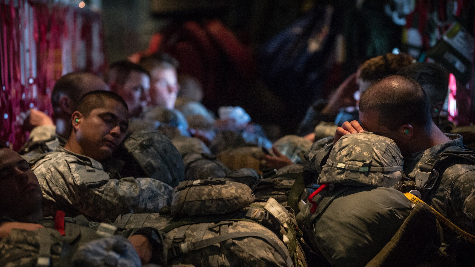U.S. Army paratroopers with the 1st Battalion, 503rd Infantry Regiment, 173rd Airborne Brigade, sleep during a flight on a 37th Airlift Squadron C-130J Super Hercules before being air dropped into Lithuania, Sept. 5, 2014, over Germany. The exercise sustains interoperability between NATO Allies and Partnership for Peace partner nation forces.  The interoperability has been gained during combat and multinational contingency operations over the past seven decades, while focusing on building capacity for the current and future operational environment. (U.S. Air Force photo/Airman 1st Class Jordan Castelan)
