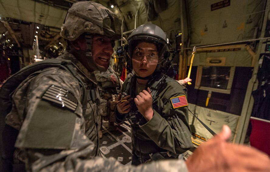 U.S. Air Force Airman 1st Class Emily Mitchell, 37th Airlift Squadron loadmaster receives the plan of action from U.S. Army Sgt. 1st Class Luis Altamirano, 4th Battalion, 319th Airborne Field Artillery Regiment jumpmaster, during a flight to airdrop paratroopers from the 1st Battalion, 503rd Infantry Regiment, 173rd Airborne Brigade, from a 37th AS C-130J Super Hercules during exercise Steadfast Javelin II over Lithuania, Sept. 5, 2014, The exercise sustains interoperability between NATO Allies and Partnership for Peace partner nation forces.  The interoperability has been gained during combat and multinational contingency operations over the past seven decades, while focusing on building capacity for the current and future operational environment. (U.S. Air Force photo/Airman 1st Class Jordan Castelan)