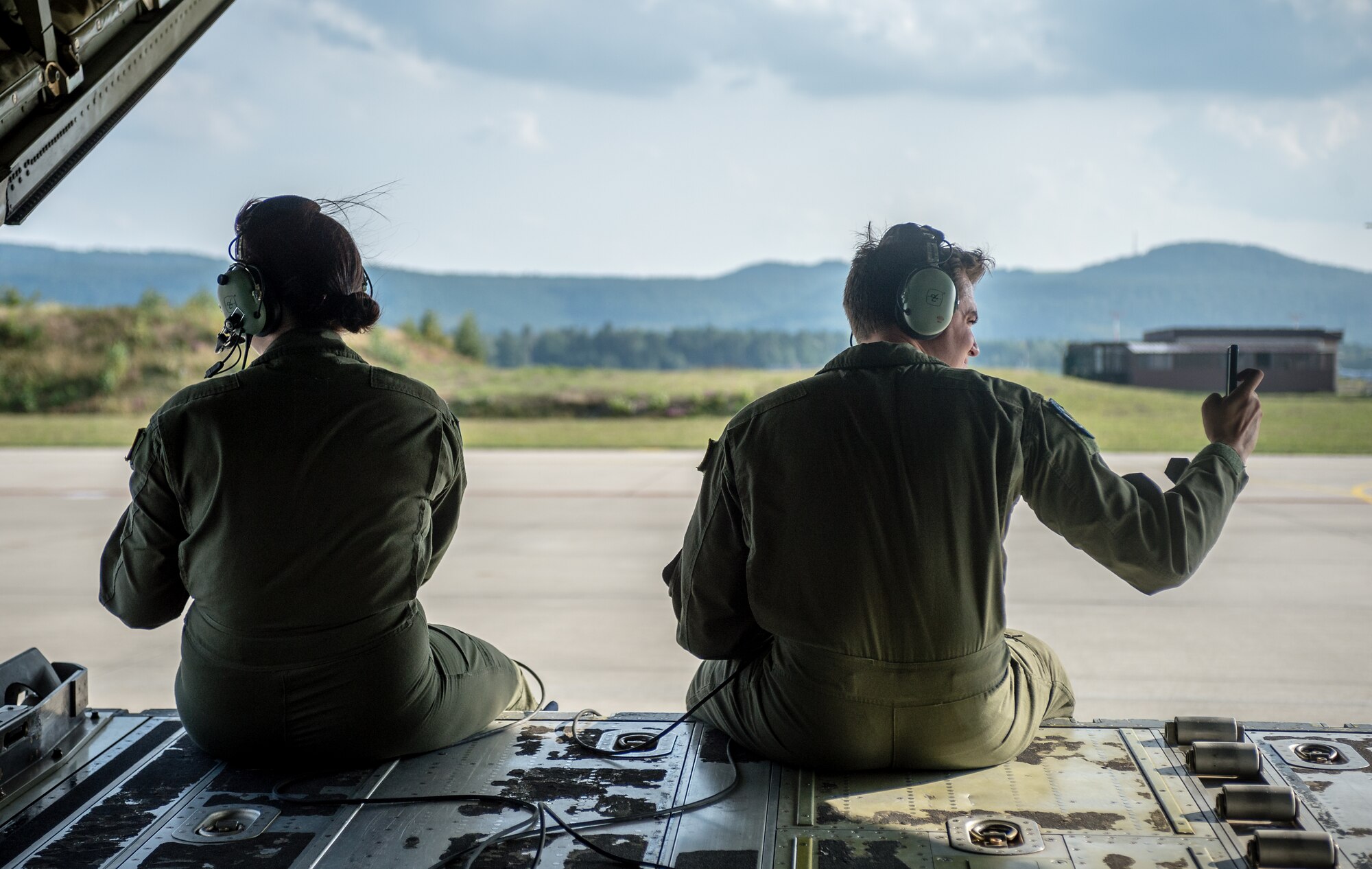 U.S. Air Force Airman 1st Class Emily Mitchell and Senior Airman Christian McDevitt, 37th Airlift Squadron loadmasters, wait to taxi on the runway in a C-130J Super Hercules during exercise Steadfast Javelin II on Ramstein Air Base, Germany, Sept. 5, 2014. The exercise sustains interoperability between NATO Allies and Partnership for Peace partner nation forces.  The interoperability has been gained during combat and multinational contingency operations over the past seven decades, while focusing on building capacity for the current and future operational environment. (U.S. Air Force photo/Airman 1st Class Jordan Castelan)