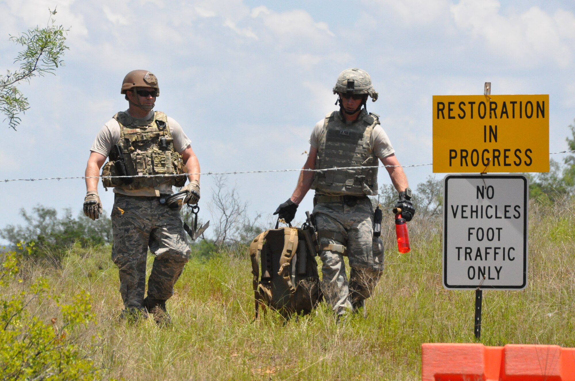 Two members of the 301st EOD team return from the report site of an unexploded ordnance at Fort Wolters, TX. (U.S. Air Force photo by Staff Sgt. Jeremy Roman)