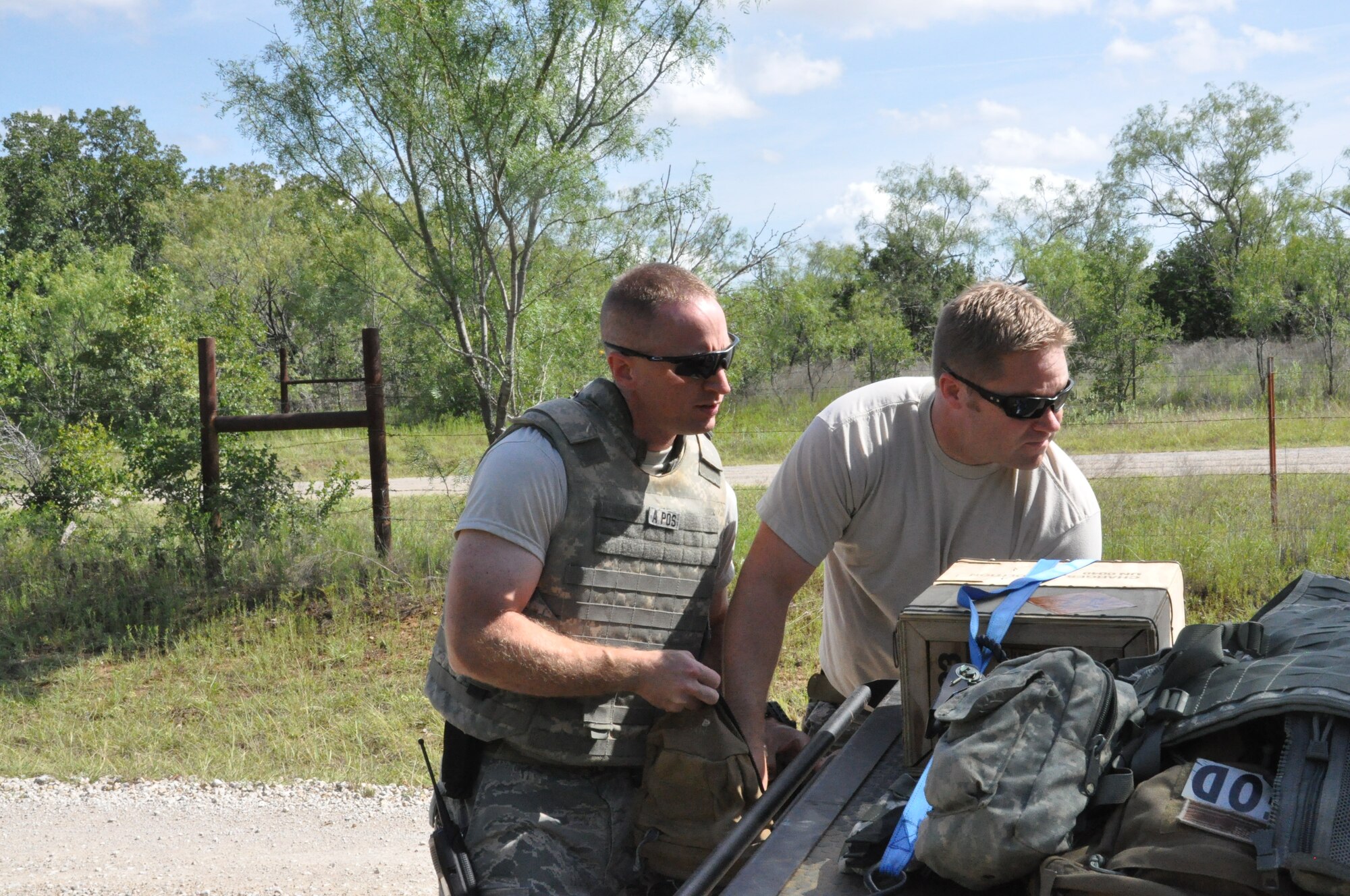 Two members of the 301st EOD team prepare their gear when responding to a report of an unexploded ordnance at Fort Wolters, TX. (U.S. Air Force photo by Staff Sgt. Jeremy Roman)