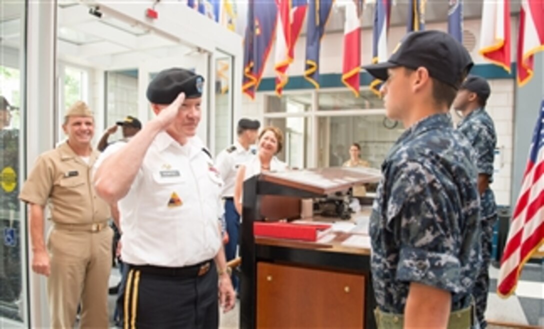Army Gen. Martin E. Dempsey, chairman of the Joint Chiefs of Staff, salutes a seaman recruit during his visit to Recruit Training Command on Naval Station Great Lakes, Ill., Sept. 5, 2014. 