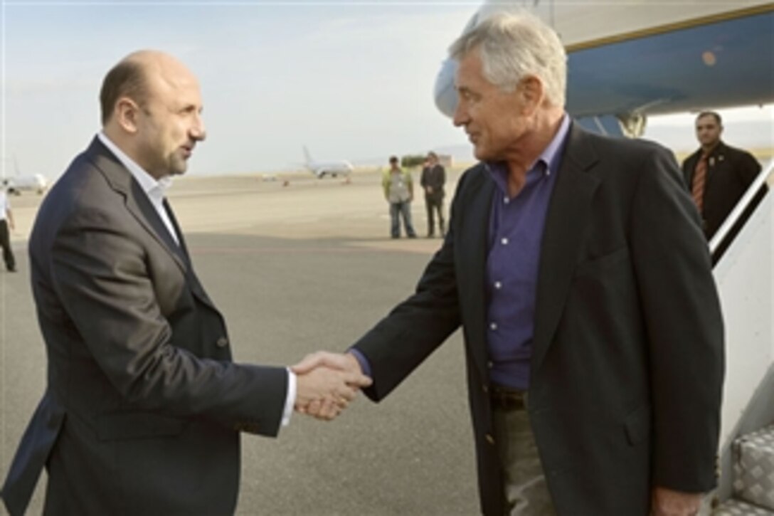 U.S. Defense Secretary Chuck Hagel, right, shakes hands with Georgian Deputy Defense Minister Mikheil Darchiashvili as he arrives in Tbilisi, Georgia, Sept. 6, 2014. Hagel is making his first visit to Georgia as defense secretary, part of a six-day international trip.