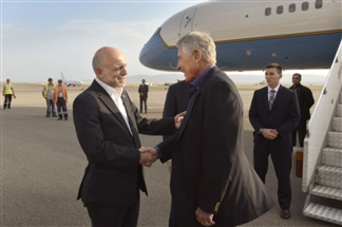 U.S. Defense Secretary Chuck Hagel, right, arrives in Tbilisi, Georgia, and shakes hands with Georgian Ambassador to the U.S. Archil Gegeshidze, Sept. 6, 2014. Hagel is making his first visit to Georgia as defense secretary, part of a six-day international trip. 