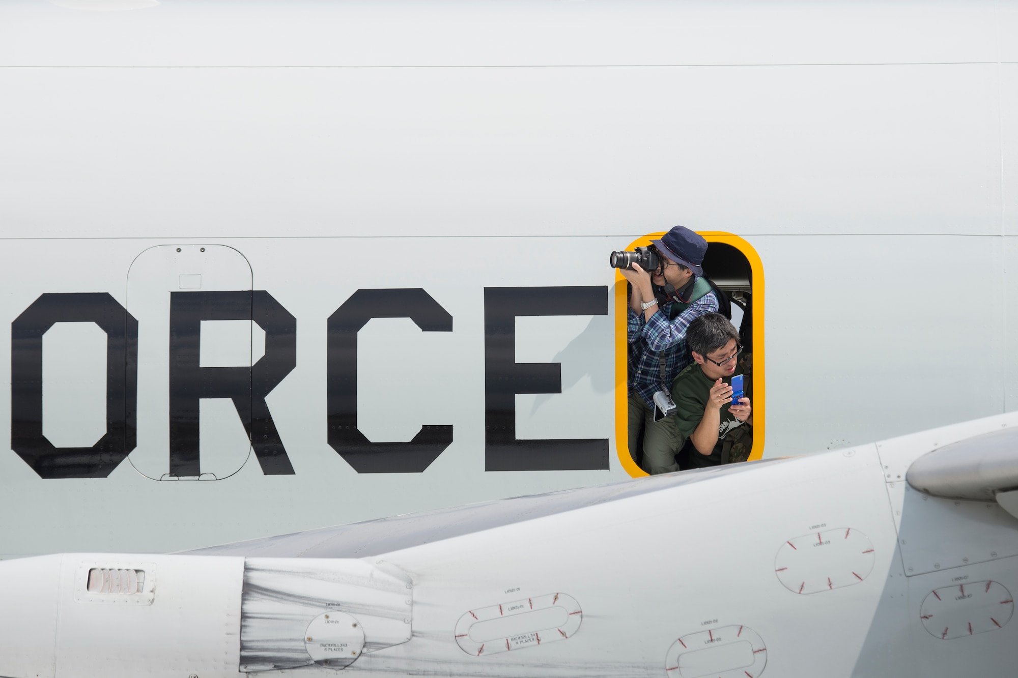 Japanese visitors enjoy taking photos from an E-3 Sentry (AWACS) at Yokota Air Base, Japan, during the Japanese-American Friendship Festival Sept. 6, 2014. Yokota welcomed approximately 148,000 visitors during the two-day festival. (U.S. Air Force photo by Osakabe Yasuo/Released)  