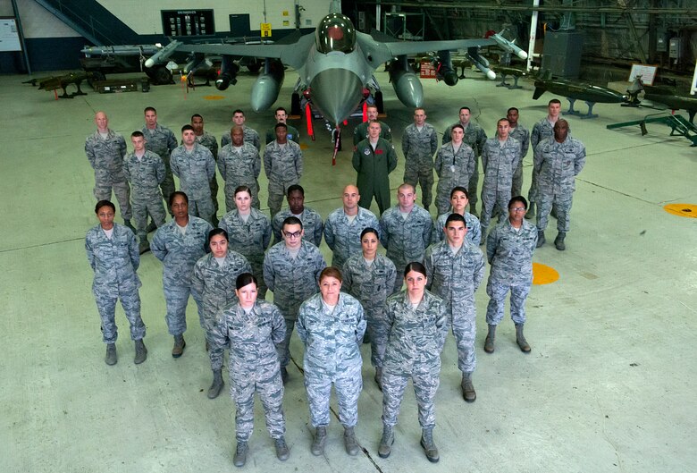 Team Osan members in front of an F-16 Fighting Falcon at Osan Air Base, Republic of Korea, Sept. 8, 2014. The Korea Readiness Orientation Program is a 30 day program to better prepare incoming Airmen for the mission in the ROK. *Parts of this photo were altered for operation security. (U.S. Air Force photo by Senior Airman Matthew Lancaster)