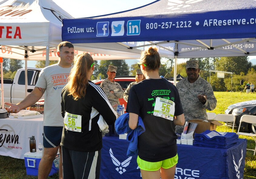 Master Sgt. James Joyal (left) and Tech. Sgt. Warren Hill (right), both recruiters with the 446th Airlift Wing, talk with participants of the 2014 Subway Beast Mode Challenge Sept. 6 at Meadowbrook Farm in North Bend, Washington. The 3.5-mile obstacle course and mud run was sponsored by Air Force Reserve Recruiting, and proceeds went to Fam 1st Foundation, which was co-created by the Seahawks’ own Marshawn Lynch to keep underprivileged youth on a positive path. (U.S. Air Force Reserve photo by MSgt Minnette Mason) 