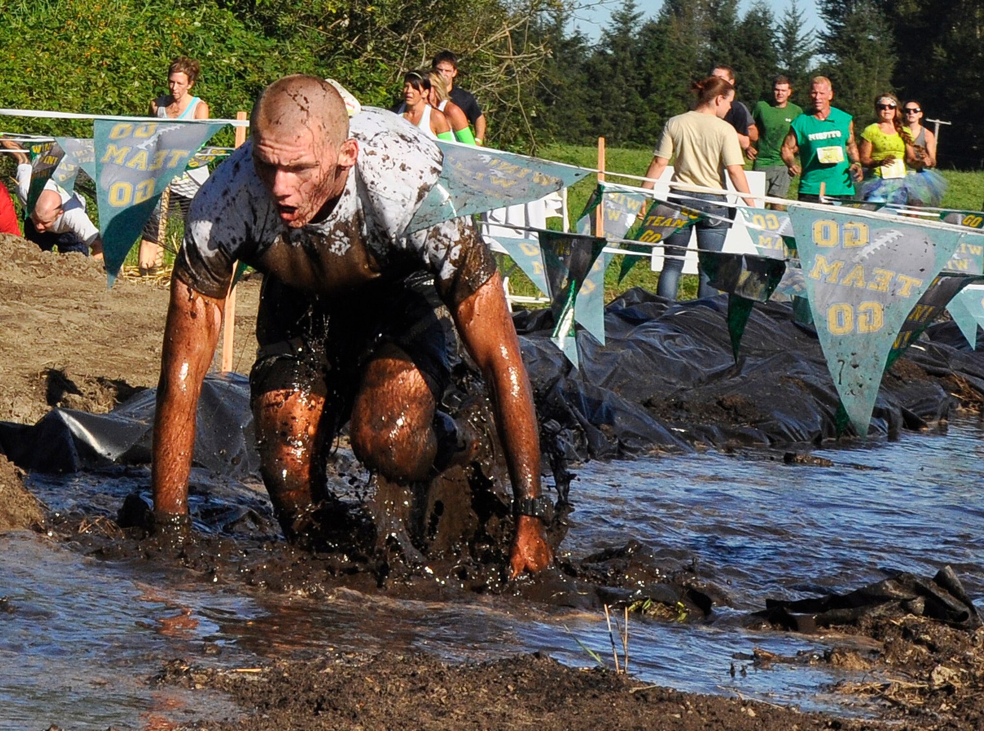 Senior Airman Kyle Knoblock, from the 446th Security Forces Squadron, surfaces from a mud trench during the 2014 Subway Beast Mode Challenge Sept. 6 at Meadowbrook Farm in North Bend, Washington. Knoblock finished the 3.5-mile obstacle course and mud run in second place of his wave. The event was sponsored by Air Force Reserve Recruiting, and proceeds went to Fam 1st Foundation, which was co-created by the Seahawks’ own Marshawn Lynch to keep underprivileged youth on a positive path. (U.S. Air Force Reserve photo by MSgt Minnette Mason)