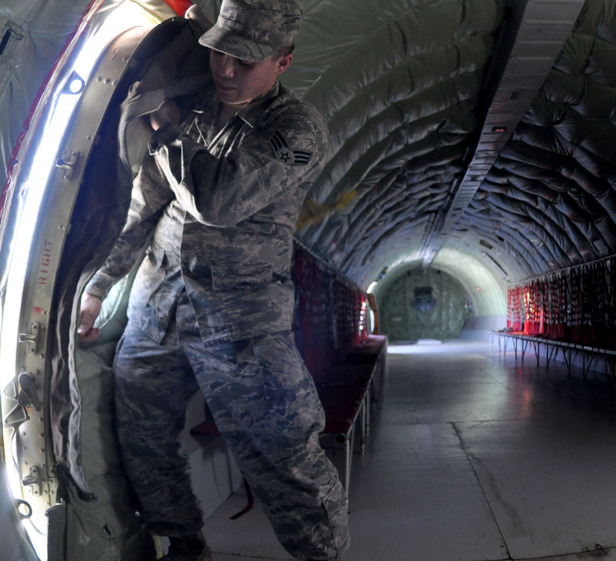 Senior Airman Kyle Brogdon, 931st Maintenance Squadron crew chief, seals the door of a KC-135A Stratotanker static display at the air park at McConnell Air Force Base, Sept. 7, 2014.  The KC-135A was recently opened and featured by members of the 931st Maintenance Squadron.  (U.S. Air Force photo by Staff Sgt. Abigail Klein)