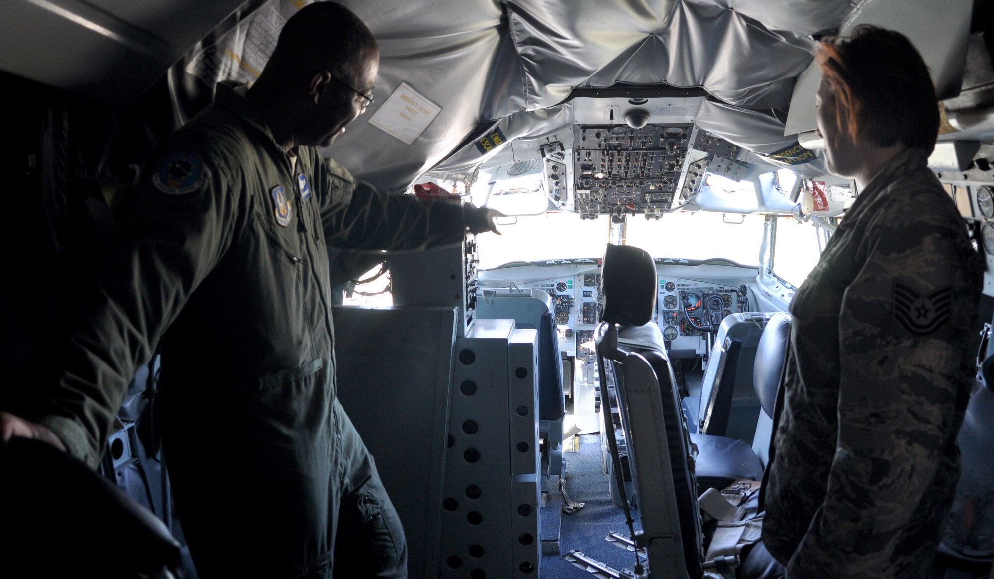 Lt. Col. Esteban Ramirez, 931st Operations Support Squadron commander, speaks with Tech. Sgt. Anne Phillips, 931st Maintenance Squadron Aerospace Propulsion craftsman, about the equipment located within the cockpit of a KC-135A Stratotanker at the air park at McConnell Air Force Base, Kan., Sept. 7, 2014.  The KC-135A static display was recently opened and featured by members of the 931st Maintenance Squadron.  (U.S. Air Force photo by Staff Sgt. Abigail Klein)