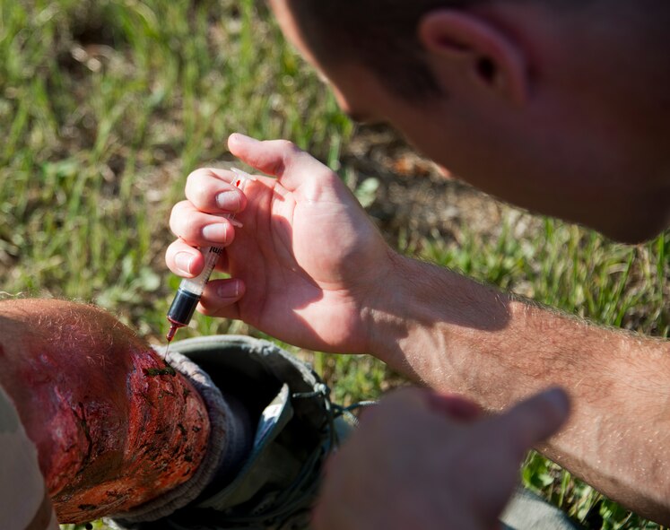 A 96th Medical Group moulage team member applies fake blood to a victim’s leg wound prior to a recent exercise at Duke Field.  The 96th MDG’s team of six Airmen provides a sense of realism in exercises that medics and first responders may encounter in real-world accidents. (U.S. Air Force photo/Tech. Sgt. Jasmin Taylor)