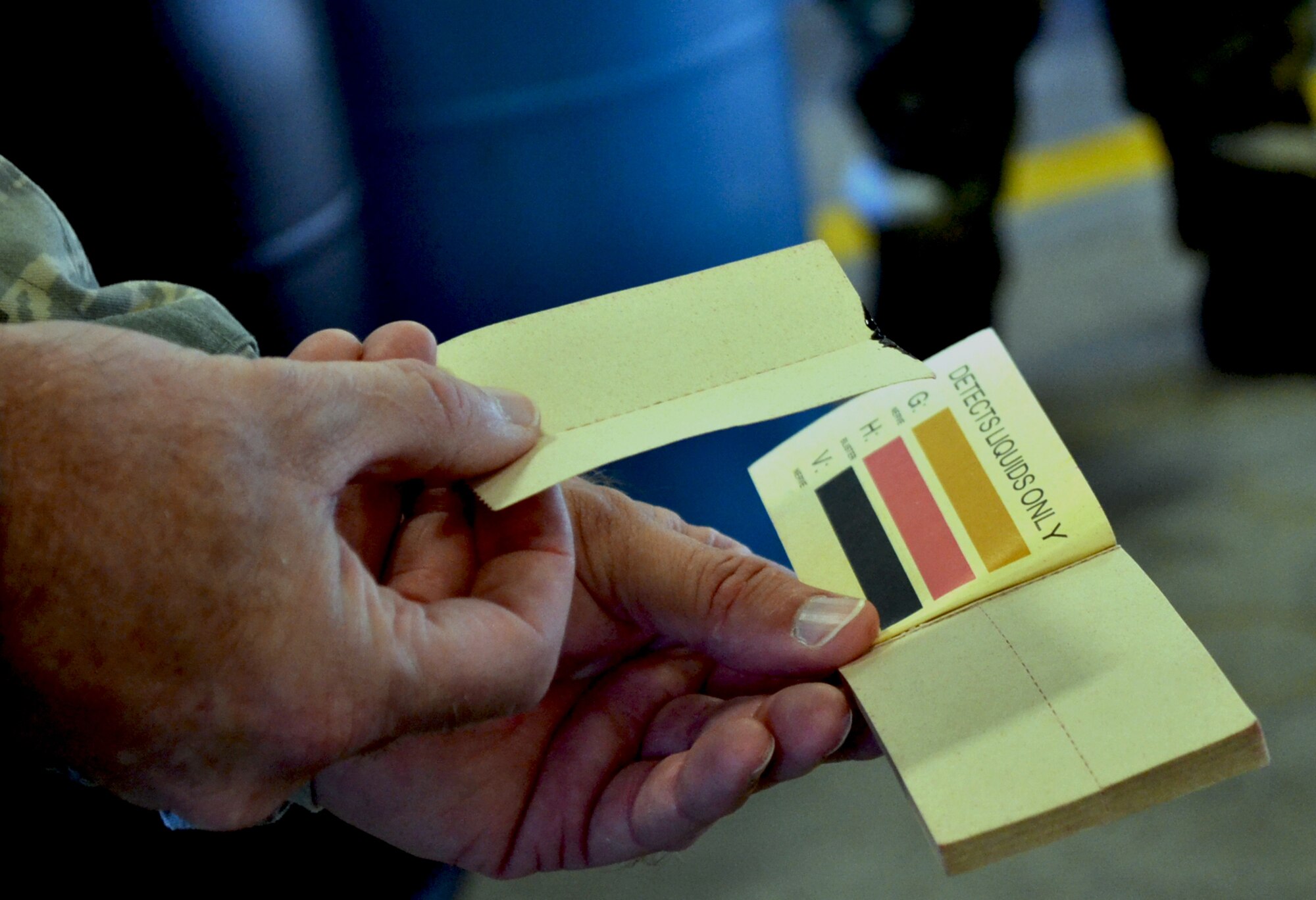 A leaflet of M8 paper dipped in oil is displayed to show what not to do when checking for chemical contamination.  M8 paper is used as a chemical detection method in training and real-life situations. (Official Air Force photo by Airman 1st Class Brigette Waltermire/Released)   