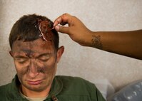 Master Sgt. Michael Sims, 5th Special Operations Squadron, has a sticky paste applied to his head to simulate a head wound, prior to a recent exercise at Duke Field.  The 96th MDG’s team of six Airmen provides a sense of realism in exercises that medics and first responders may encounter in real-world accidents. (U.S. Air Force photo/Tech. Sgt. Jasmin Taylor)