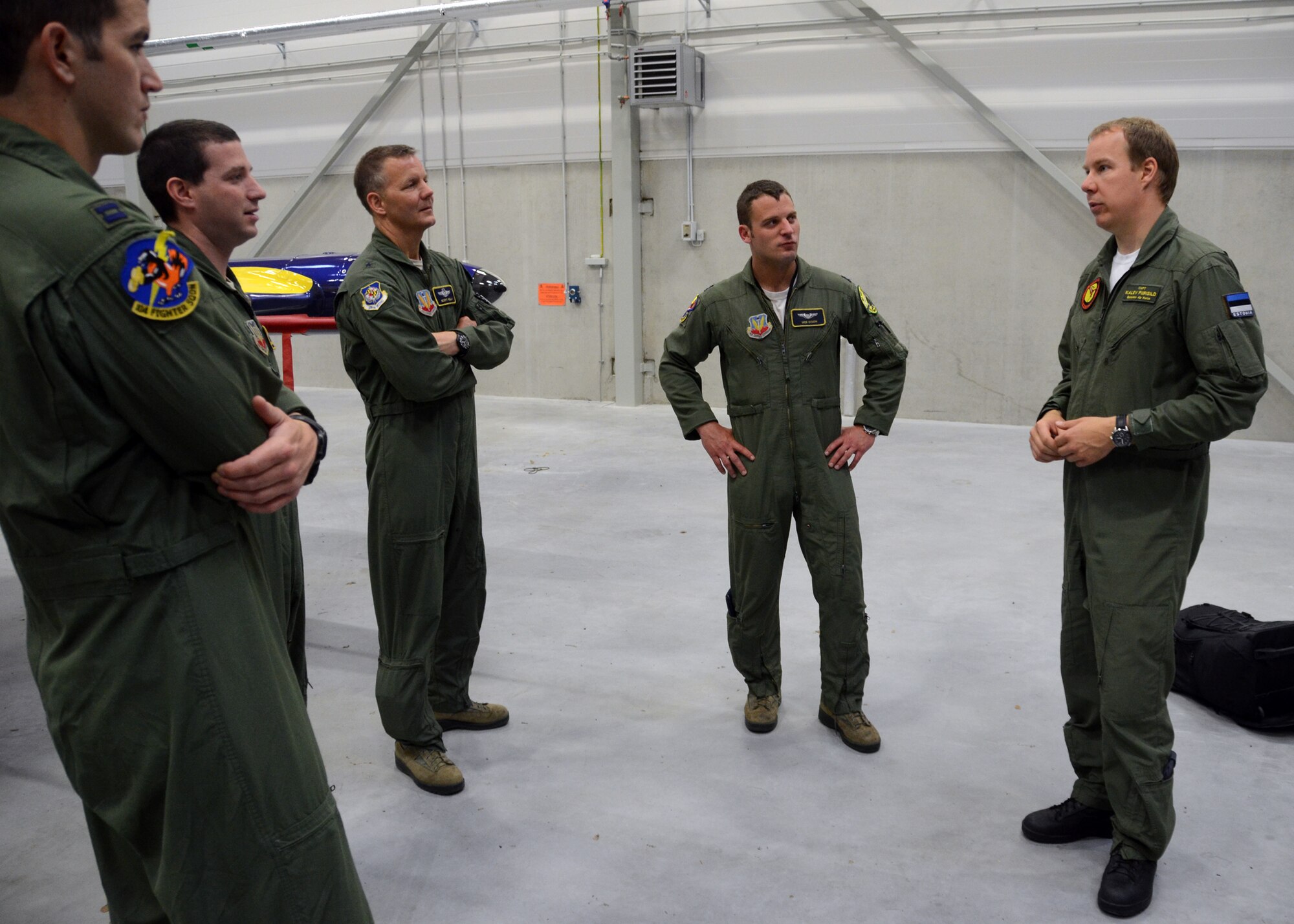 Captain Daniel Griffin, left, an A-10C pilot with Maryland Air National Guard, listens to Estonian Air Force Capt. Kalev Piirisild addresses a group of pilots assigned 
to the 104th Fighter Squadron, during Sabre Strike at Amari Air Base, Estonia on June 4, 2013. Griffin has been assigned the new Bilateral Affairs Officer for Estonia. A Bilateral Affairs Officer is a United States Army or Air National Guard officer recruited from the state National Guard unit of which he or she is a member. In the National Guard State Partnership Program, each state has a 'partner country' and the Bilateral Affairs Office serves as a conduit between the two. It is considered a diplomatic level assignment. .  (U.S. Air National Guard photo by Staff Sgt. Benjamin Hughes)
