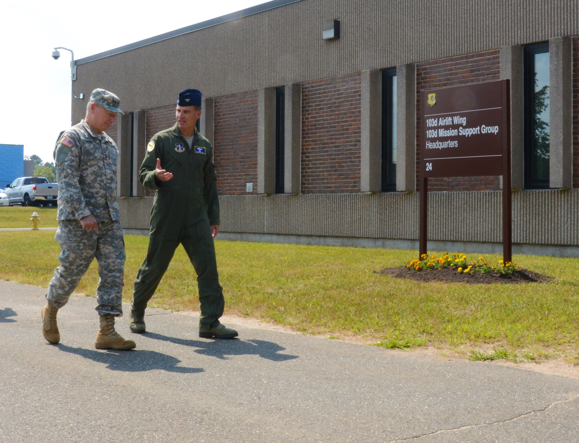 Col. Frank Detorie, commander of the 103rd Airlift Wing, and Gen. Frank J. Grass, Chief of the National Guard Bureau, walk to wing headquarters to meet with the Flying Yankees, Sept. 6, 2014, at Bradley Air National Guard Base, East Granby, Conn. Grass held a townhall meeting at headquarters, taking the time to answer questions from 103rd Airmen. (U.S. Air National Guard photo by Senior Airman Jennifer Pierce)