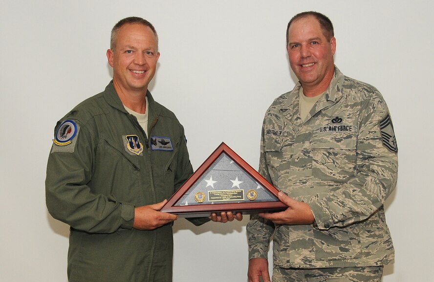 185th Air Refueling Wing Commander Col Larry Christensen presents Chief Master Sgt. Mark Vander Molen with a U.S. flag on the occasion of his retirement on Sept 6, 2014 in Sioux City, Iowa. Vander Molen a long time unit member retired from the 185th Civil Engineering Squadron after 37 years of service.
U.S. Air National Guard Photo by: Master Sgt Vincent De Groot 185th ARW Wing Public Affairs/Released
