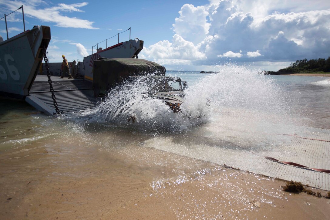 U.S. Marines with Company I, Battalion Landing Team 3rd Battalion, 5th Marines, 31st Marine Expeditionary Unit (MEU), offload a Humvee from a Landing Craft, Utility belonging to Navy Beach Unit 7, as part of Amphibious Integration Training (AIT) at Kin Blue, Okinawa, Japan, Sept 4, 2014. The Marines, partnered with Amphibious Squadron-11, are conducting AIT aboard the USS Peleliu (LHA-5) in support of the regularly scheduled Fall Patrol ‘14.