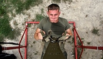 Sgt. Matt Boulis, a recruiter with Recruiting Sub-station Grand Rapids North, Recruiting Station Lansing, performs a supine pull-up during an all-hands physical training session Sept. 4 in Holt, Mich. The circuit course style session traversed nearly three  miles and included a number of pull-up variations, kettle-bell exercises, medicine ball throws, and partner abdominal workouts. Over 60 Marines participated in the event,including 9th Marine Corps District Commanding officer, Col. Jason Morris, and 9th MCD Sgt. Maj., Sgt. Maj. John Hawes. 