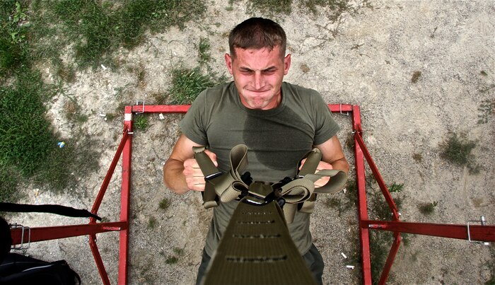 Sgt. Matt Boulis, a recruiter with Recruiting Sub-station Grand Rapids North, Recruiting Station Lansing, performs a supine pull-up during an all-hands physical training session Sept. 4 in Holt, Mich. The circuit course style session traversed nearly three  miles and included a number of pull-up variations, kettle-bell exercises, medicine ball throws, and partner abdominal workouts. Over 60 Marines participated in the event,including 9th Marine Corps District Commanding officer, Col. Jason Morris, and 9th MCD Sgt. Maj., Sgt. Maj. John Hawes. 