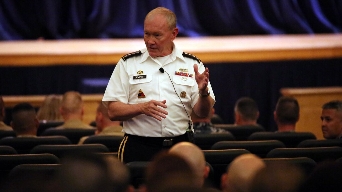 Chairman of the Joint Chiefs of Staff Gen. Martin Dempsey answers a question during a town hall meeting with Marines, sailors and former service members aboard Naval Station Great Lakes, Ill., Sept. 5. Dempsey discussed a wide range of topics including involvement in the Middle East, and how budget cuts affect service members worldwide.