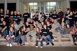 Soldiers from Task Force Aviation, Multinational Battle
Group East, pose with local teenagers after a memorial service in downtown Ferizaj/Urosevac, Kosovo, Sept. 11, 2010. The National Guard Soldiers are part of an outreach program that is designed to teach English to local teenagers. The Soldiers joined their students to hold a memorial service to remember the lives lost on Sept. 11, 2001.