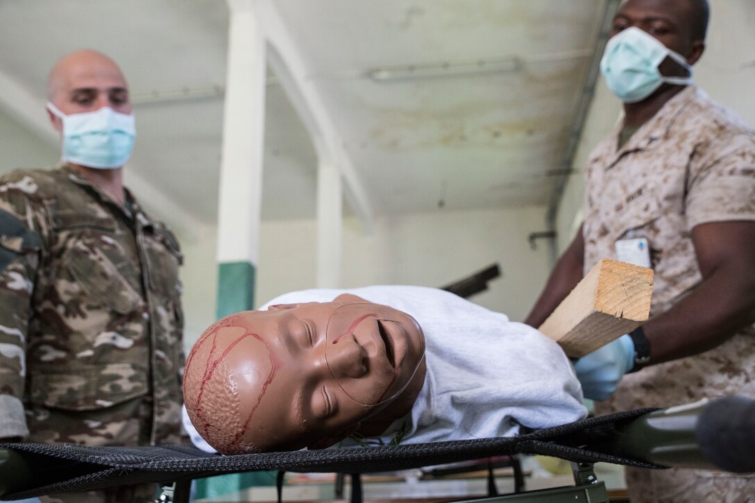 Lance Cpl. Johnny Alston (right), a personnel retrieval and processing specialist with PRP Company, 4th Marine Logistics Group, Marine Forces Reserve, and Sgt. 1st Class Matevz Scheicher, a weapons specialist with the Slovenian army, inspect and document simulated remains during the culminating event of exercie Immediate Response 2014 here, Aug. 25-27, 2014 PRP’s mission is to process the physical remains of deceased Marines, including other service members and civilians, ensuring  everything they arrived at the disaster site with, he or she returns home with. (U.S. Marine Corps photo by Cpl. Codey Underwood)
