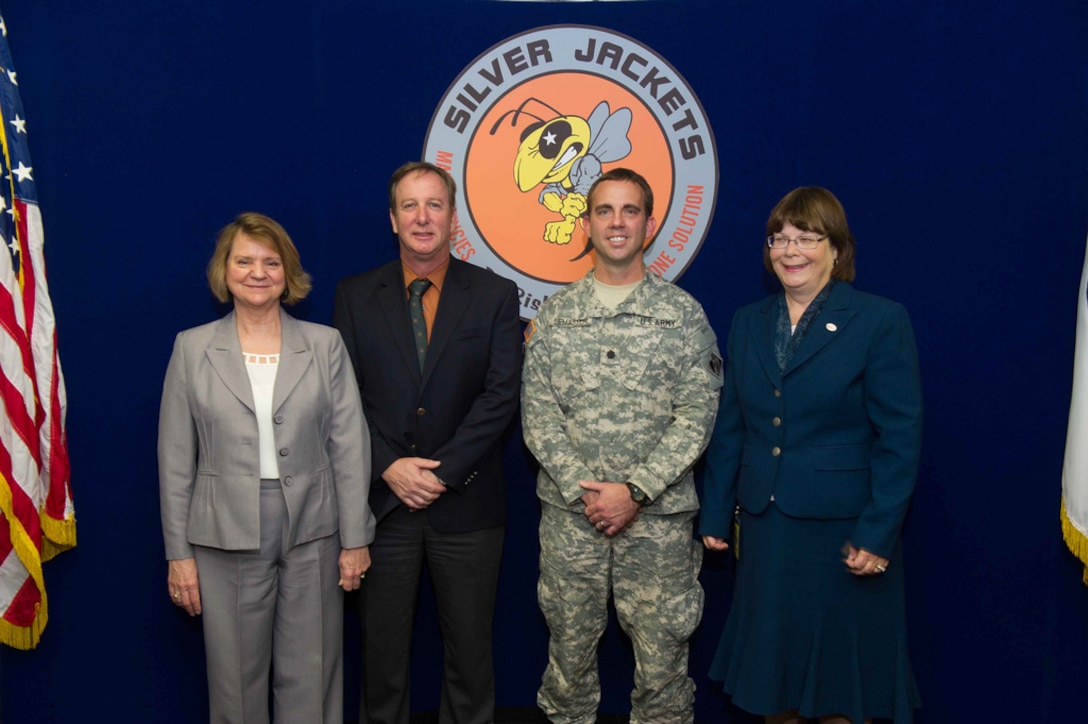 Program leaders for California’s new Silver Jackets team Terri Wegener (left), with the California Department of Water Resources, and Judy Soutiere (right), with the U.S. Army Corps of Engineers Sacramento District, pose with DWR Deputy Director of Integrated Water Management Gary Bardini and Sacramento District Deputy Commander Lt. Col. Braden LeMaster after a ceremony celebrating the new team in Sacramento, California, Nov. 4, 2013. The Silver Jackets program is designed to improve coordination, collaboration and communication among disaster-response agencies at all levels of government before a disaster strikes to hasten recovery. California is the 40th state to establish a Silver Jackets team.