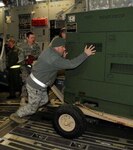 Airmen with the 188th Fighter Wing of the Arkansas Air National Guard load billets onto a C-17 Jan. 25. The billets are part of the unit's Disaster Relief Beddown Set (DRBS). The 188th was tasked with deploying its DRBS in support of Operation Unified Response.