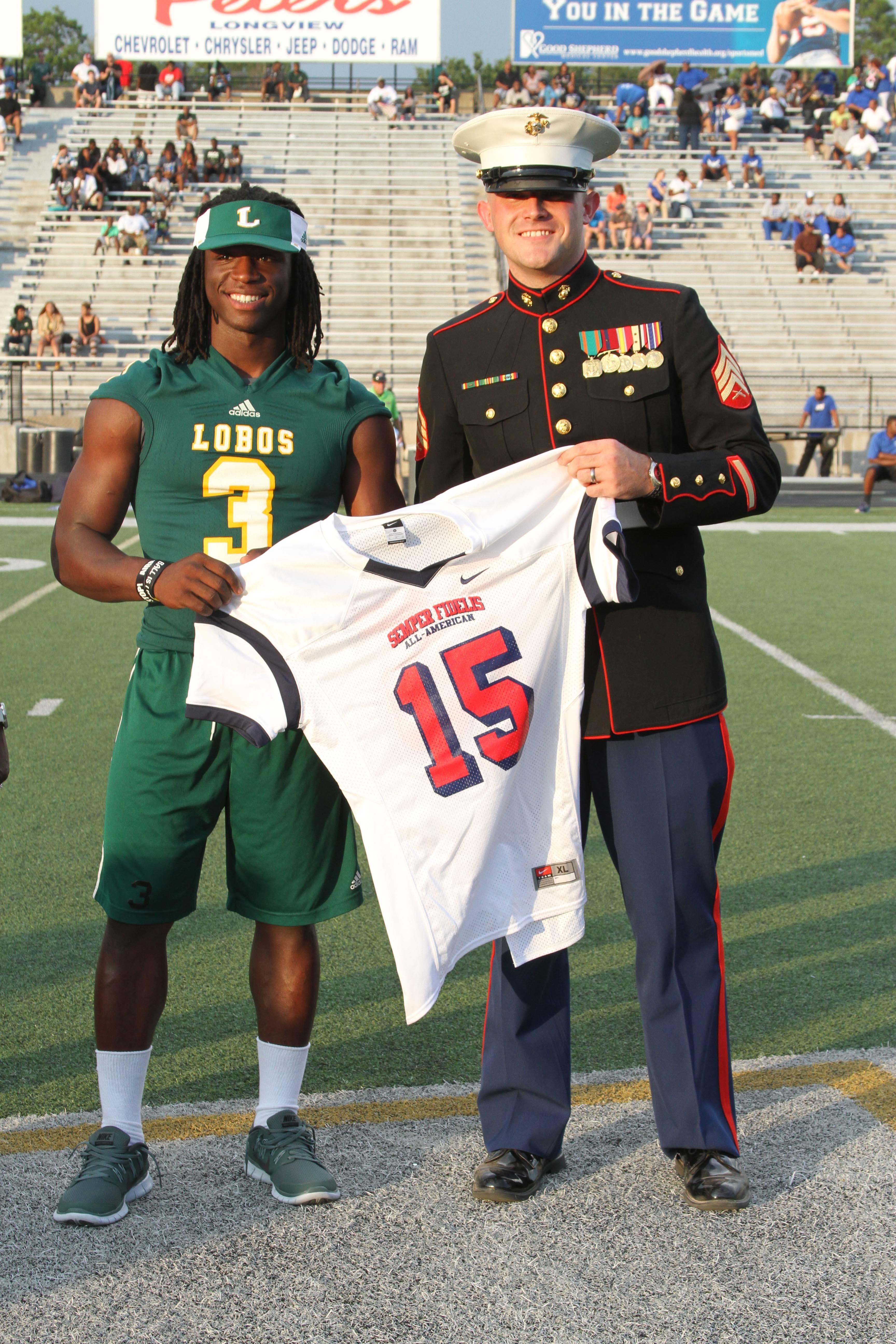 Jamycal Hasty Receives Semper Fidelis Bowl Jersey