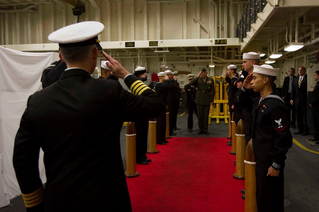 Captain Michael Baze, executive officer of the future amphibious assault ship USS America (LHA 6), renders honors to Gen. John Kelly, commander of U.S. Southern Command, as he comes aboard the ship for an evening reception in Peru, Sept. 1, 2014. The reception was hosted by the Marines, Sailors aboard the ship and U.S. Ambassador to Peru Brian A. Nichols. The formal evening consisted of food, music and dancing, concluding with the presentation of the colors and speeches from Rear Adm. Frank L. Ponds, commander of Expeditionary Strike Group 3, and Ambassador Nichols. Marines and Sailors with Special Purpose Marines Air Ground Task Force South are currently embarked aboard America in support of her maiden transit, "America Visits the Americas." The transit is a clear example of our nation's commitment to our regional partners and allies. (U.S. Marine Corps Photo by Cpl. Donald Holbert/ Released)