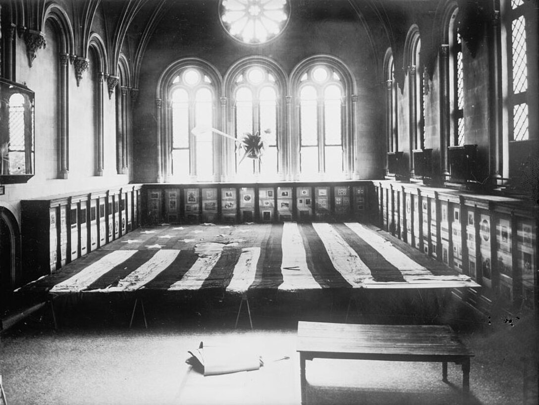 Flag which floated over Fort McHenry [in 1814], displayed horizontally in a room surrounded by cases, 4 June 1914.