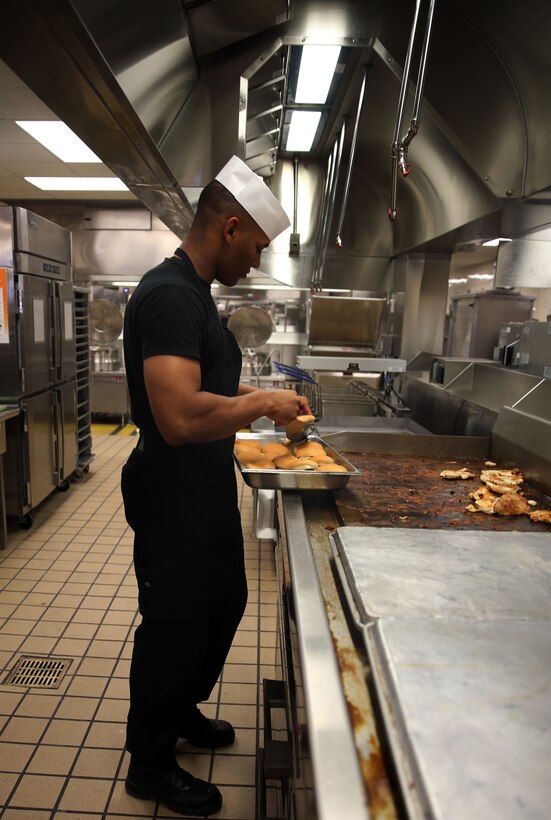 Pvt. Rayvon Williams prepares hamburgers in the newly kitchen of the renovated mess hall at Marine Corps Air Station Cherry Point, N.C., Sept. 3, 2014. The mess hall recently underwent major renovations and features a relaxing atmosphere for patrons. Williams is a food service specialist with Headquarters and Headquarters Squadron here.