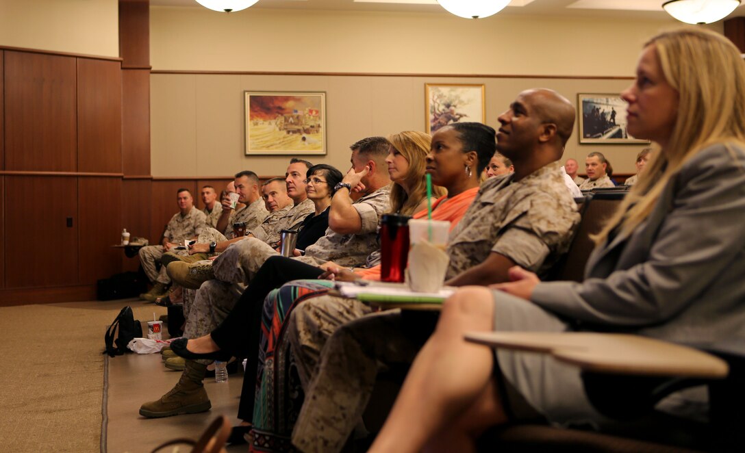 The Marines and spouses of 4th Marine Logistics Group gather together for a brief on the Family Readiness Program while attending the Commander’s Conference at the Marine Corps Support Facility, New Orleans, Sep. 6, 2014. The Marines and their spouses all attended various briefs including information on the commander’s intent, how 4th MLG is continuing to be ready, relevant and responsive, and how families can maintain their readiness.