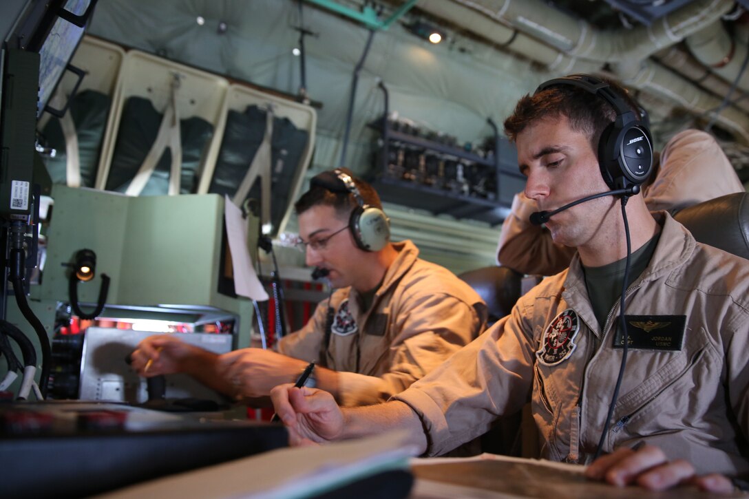 Capt. Craig Fitzhugh, left, and Capt. Mike Jordan operate the Harvest Hercules Airborne Weapons Kit system in the back of a modified KC-130J Super Hercules at Marine Corps Air Station Cherry Point, N.C., Sept. 2, 2014. The Harvest HAWK system allows KC-130J pilots to provide close-air support mission and aerial reconnaissance for the Marines on the ground. Fitzhugh and Jordan are both KC-130J pilots with Marine Aerial Refueler Transport Squadron 252.
