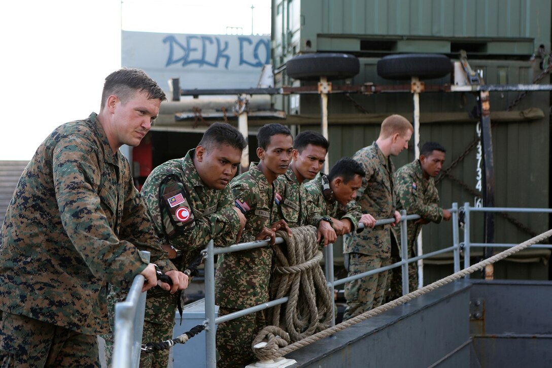 Marines with Echo Company, Battalion Landing Team 2nd Battalion, 1st Marines, 11th Marine Expeditionary Unit, gives members of the Malaysian Armed Forces a tour of the USS Comstock during Malaysia-United States Amphibious Exercise 2014 Aug. 30. MALUS AMPHEX 14 is designed to allow the 11th MEU to work with the Malaysian Armed Forces to hone their amphibious capabilities by conducting amphibious rehearsals with ship-to-shore connectors and utilizing the rapid response planning processes. (U.S. Marine Corps photo by Sgt. Melissa Wenger/Released)