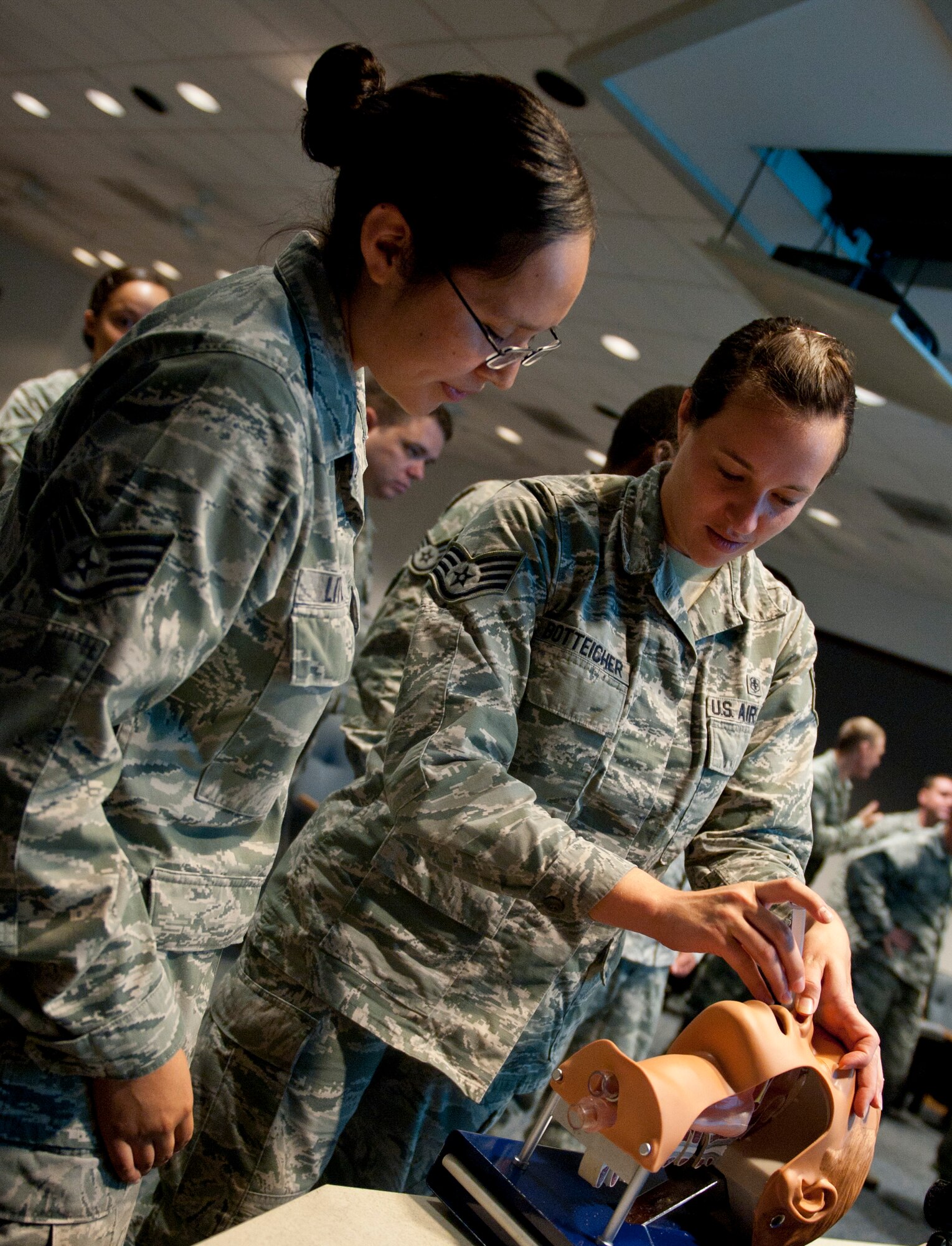 Staff Sgt. Jillian Botteicher, 1st Special Operations Aerospace Medicine Squadron public health technician, is instructed by Staff Sgt. Kelsey Little, 1st Special Operations Medical Group education and training and Self-Aid Buddy Care wing advisor, on the proper way to insert a nasopharyngeal airway during a SABC course at Hurlburt Field, Fla., Sept. 4, 2014. If a person does not have a clear airway, their potential of dying is greatly increased. (U.S. Air Force photo/Senior Airman Krystal M. Garrett) 