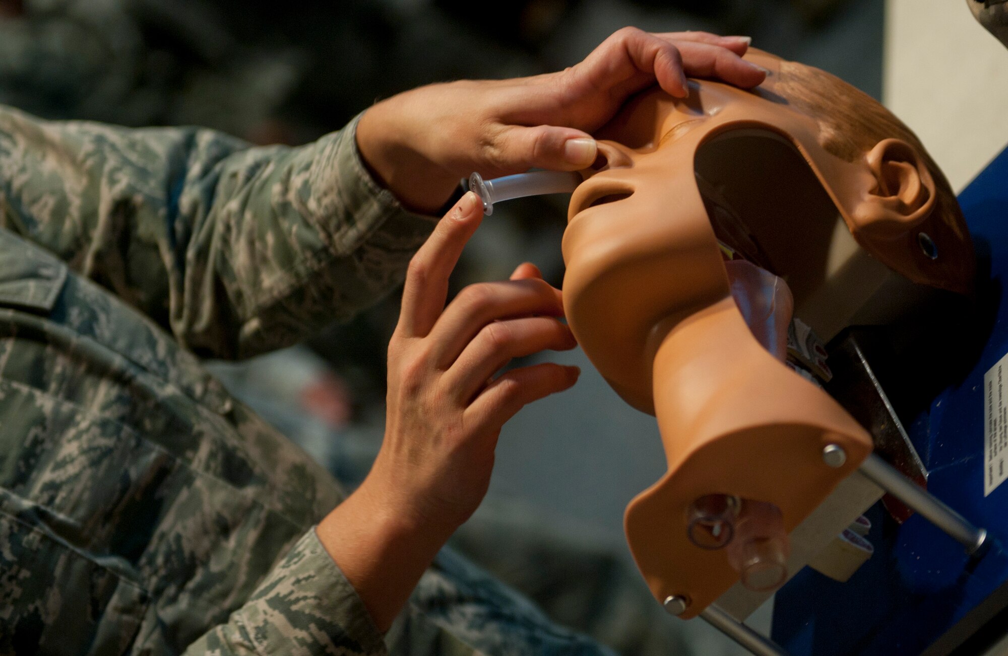 Staff Sgt. Jillian Botteicher, 1st Special Operations Aerospace Medicine Squadron public health technician, inserts a nasopharyngeal airway during a Self-Aid Buddy Care Instructor course on Hurlburt Field, Fla., Sept. 4, 2014. Providing an airway for a person in need is a critical life-saving skill. (U.S. Air Force photo/Senior Airman Krystal M. Garrett)