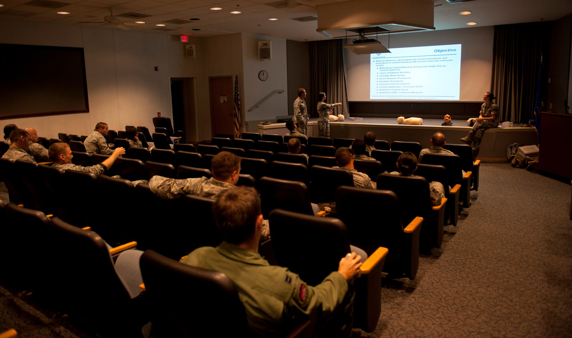 Senior Airman Austin Olin and Airman 1st Class Javiann Ayala, 1st Special Operations Security Forces Squadron patrolmen, brief the Self-Aid Buddy Care instructor about bleeding control at Hurlburt Field, Fla., Sept. 4 2014. During the course, Airmen learned how to teach and evaluate others on basic life and limb preserving skills. (U.S. Air Force photo/Senior Airman Krystal M. Garrett)  