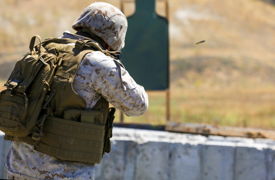 Corporal Alberto Perez III engages his target during a table three shoot aboard Marine Corps Base Camp Pendleton, Calif., Sept. 4, 2014. Table three is part of the Combat Marksmanship Program, which is designed to keep Marines in a combat mindset and ready for what the mission might demand. Perez is an administration specialist with the 15th Marine Expeditionary Unit. (U.S. Marine Corps photo by Cpl. Anna Albrecht/Released)