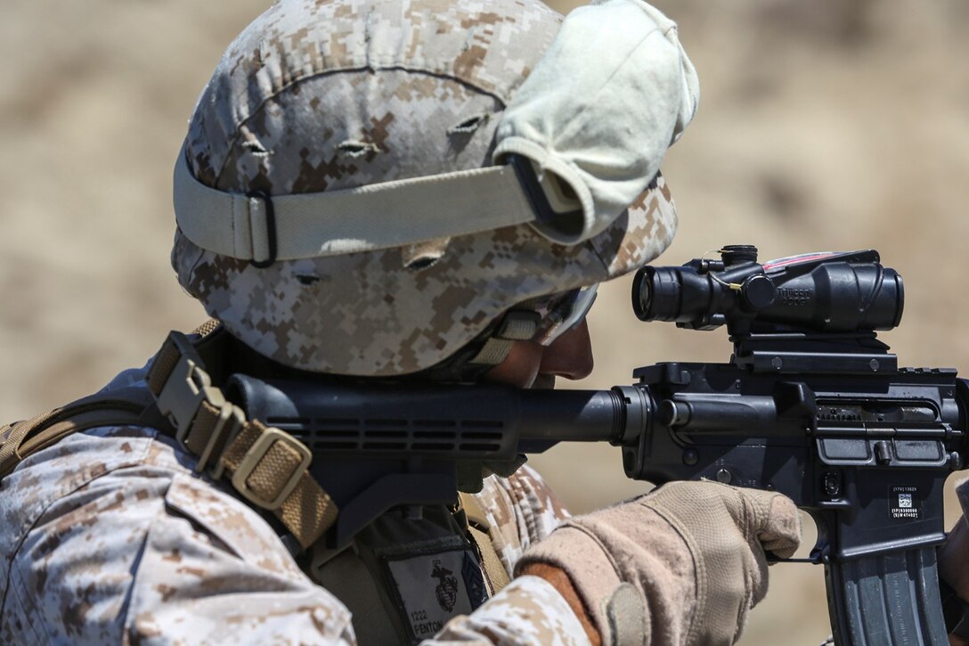 Master Sgt. Raul Penton sights in on his target before engaging it during a table three shoot aboard Marine Corps Base Camp Pendleton, Calif., Sept. 4, 2014. Table three is part of the Combat Marksmanship Program, which is designed to keep Marines in a combat mindset and ready for what the mission might demand. Penton is a communications chief with the 15th Marine Expeditionary Unit. (U.S. Marine Corps photo by Cpl. Anna Albrecht/Released)