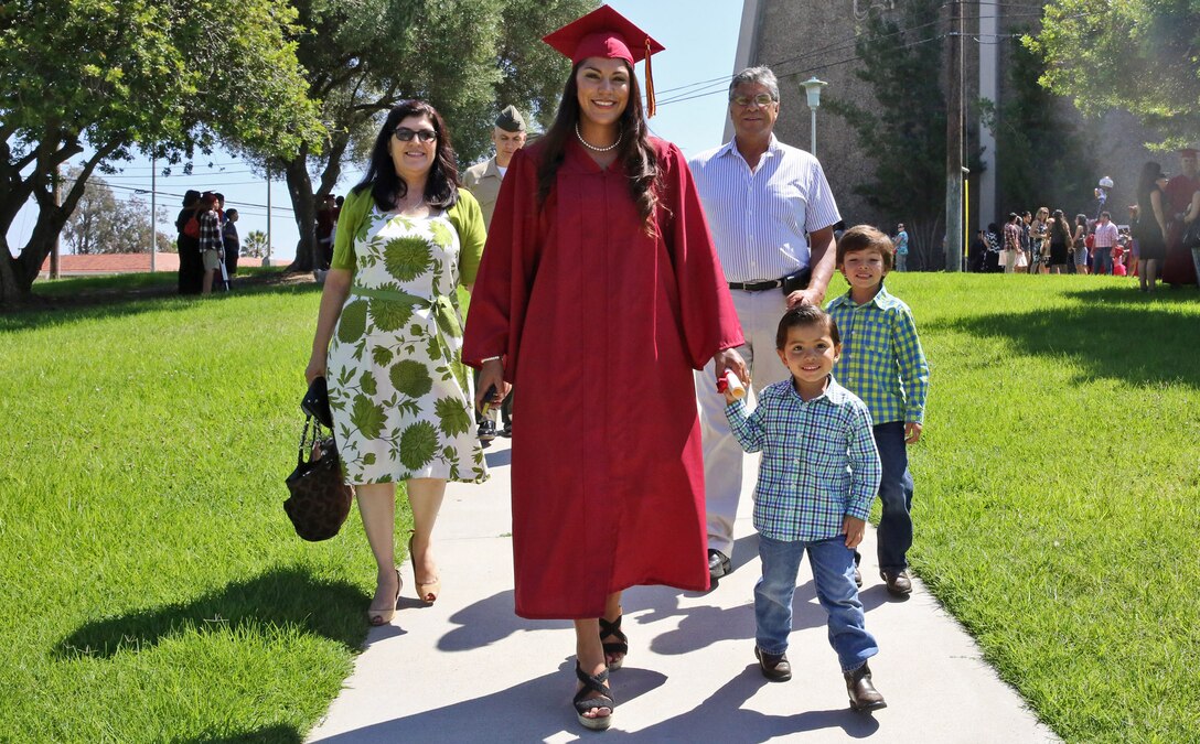 Jessica Pinon, a military spouse walks with her family after her graduation ceremony at Camp Pendleton, Calif., Sept. 5. Each year, Marines and their family are given the chance to pursue higher education with the post 9/11 G.I. Bill and tuition assistance program at the Joint Education Centers on base. Several colleges offere associate and bachelor degrees at the JEC where there is a combination of online and on-campus instruction and coursework.

(U.S. Marine Corps photo by Cpl. Shaltiel Dominguez)
