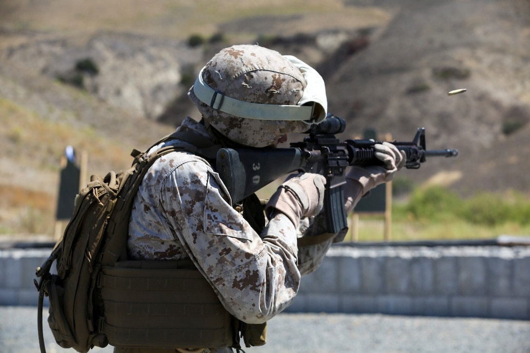 Corporal Rene Gonzalez engages his target during a table three shoot aboard Marine Corps Base Camp Pendleton, Calif., Sept. 4, 2014. Table three is part of the Combat Marksmanship Program, which is designed to keep Marines in a combat mindset and ready for what the mission might demand. Gonzalez is a data network specialist with the 15th Marine Expeditionary Unit. 