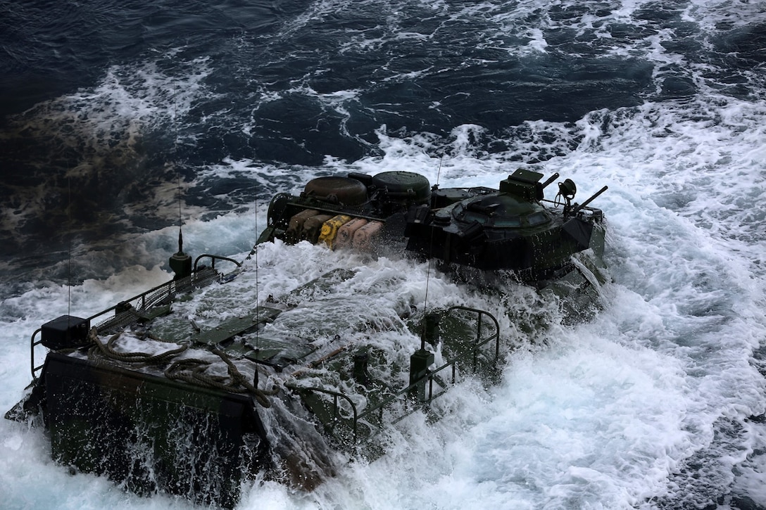 An amphibious assault vehicle with Echo Company, Battalion Landing Team 2nd Battalion, 1st Marines, 11th Marine Expeditionary Unit, leaves the well deck of the USS Comstock during Malaysia-United States Amphibious Exercise 2014 Aug. 30. MALUS AMPHEX 14 is a bilateral exercise between the 11th MEU and Malaysian Armed Forces designed to foster and sustain cooperative and international relationships with emphasis on amphibious and humanitarian operations within the context of a stability and security operation. 