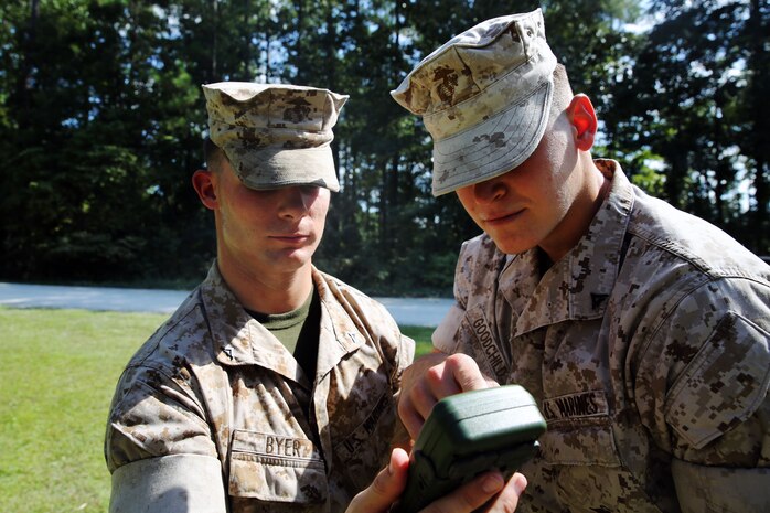 Lance Cpl. Joshua Byer, left, and Lance Cpl. Justin Goodchild use a Defense Advanced GPS Receiver to check a heading during a land navigation test at Marine Corps Air Station Cherry Point, N.C., Sept. 3, 2014. Byer and Goodchild are both gunners with 2nd Low Altitude Air Defense Battalion, practicing their land navigation skills during team leaders course. Byer is a native of Columbus, Ohio and Goodchild is a native of Longwood, Fla.